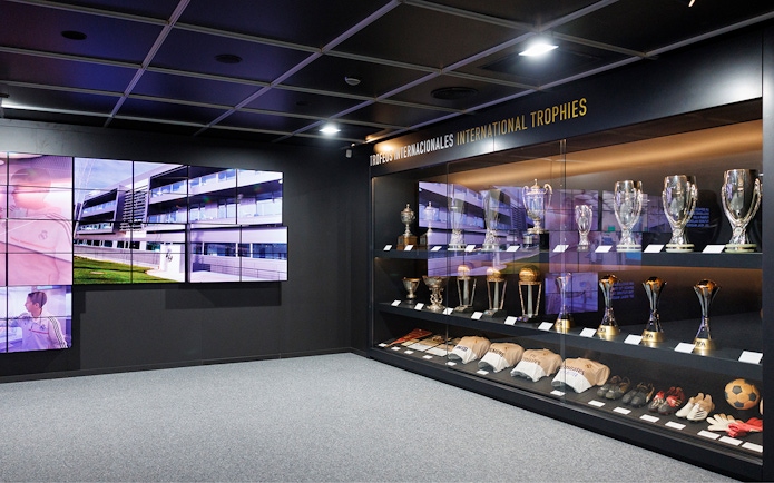 Trophy display inside Santiago Bernabeu Stadium with international awards.