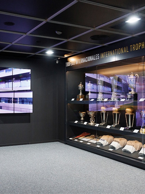 Trophy display inside Santiago Bernabeu Stadium with international awards.