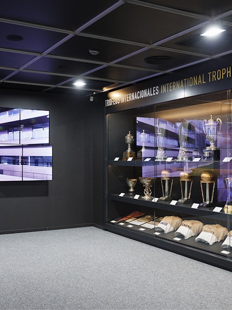 Trophy display inside Santiago Bernabeu Stadium with international awards.