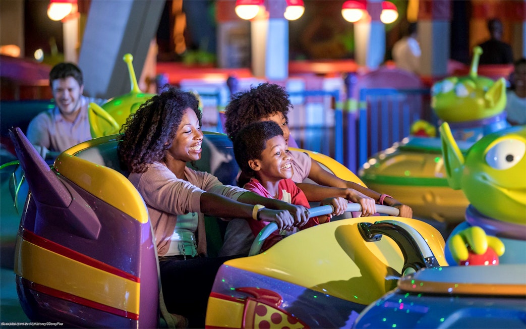 Family enjoying bumper cars at Toy Story attraction, Walt Disney World Resort, Orlando.