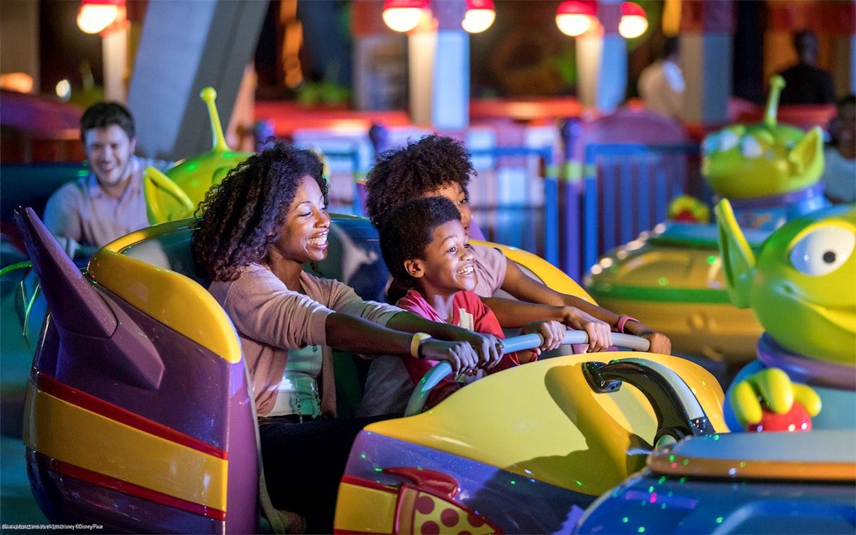 Family enjoying bumper cars at Toy Story attraction, Walt Disney World Resort, Orlando.