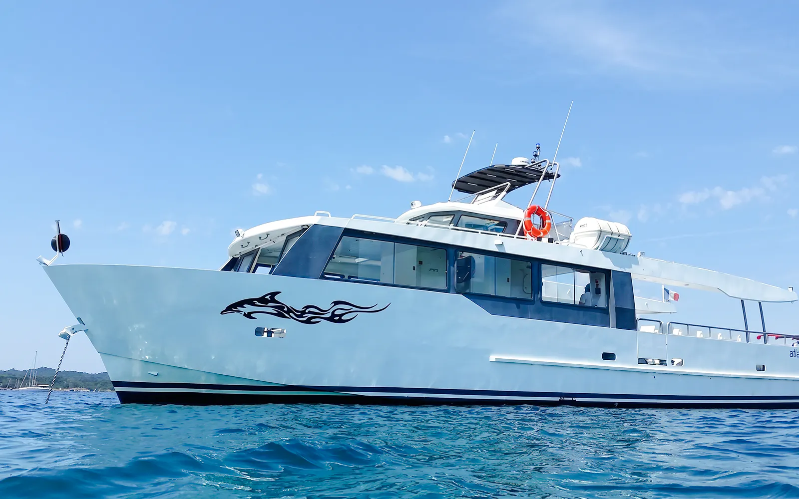 Tour boat cruising on clear waters during Monaco boat tour.
