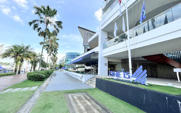 Marina club entrance with palm trees, Singapore, for Cruise And Dine experience.