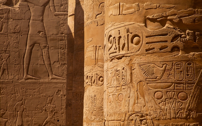 Intricate hieroglyphs on temple columns in Egypt.
