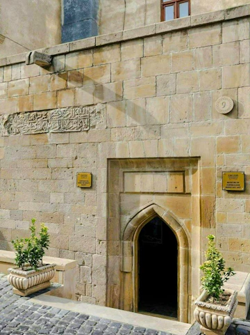 Entrance to the Museum of Azerbaijani Miniature Art with stone archway and decorative plaques.