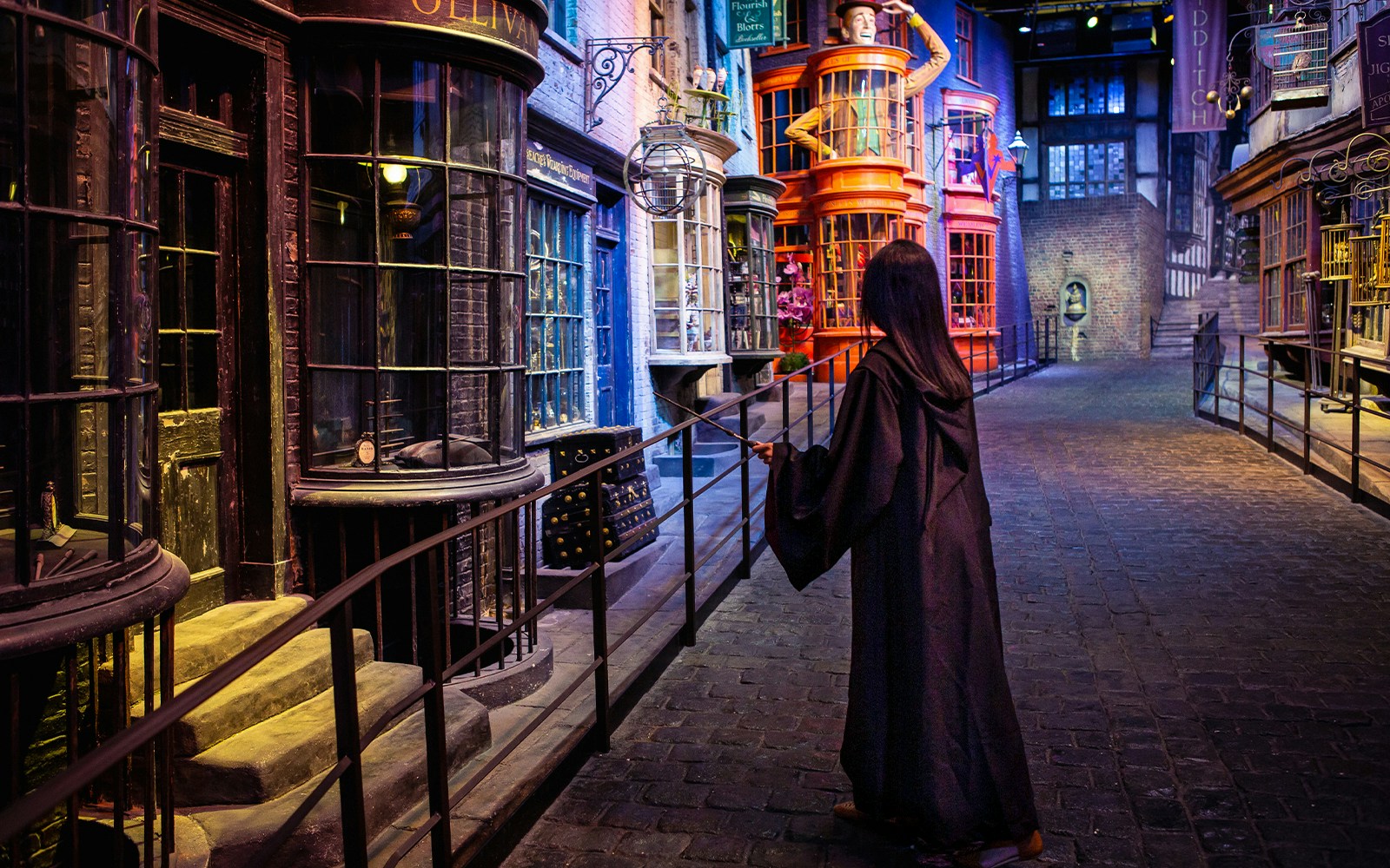 Diagon Alley at Harry Potter Warner Bros. Studio Tour, London, with a person in wizard robes.