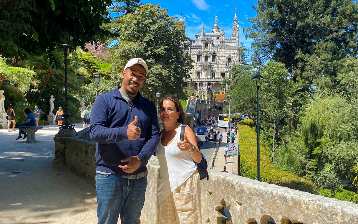 Tourist with guide in front of Quinta da Regaleira, Sintra, Portugal.