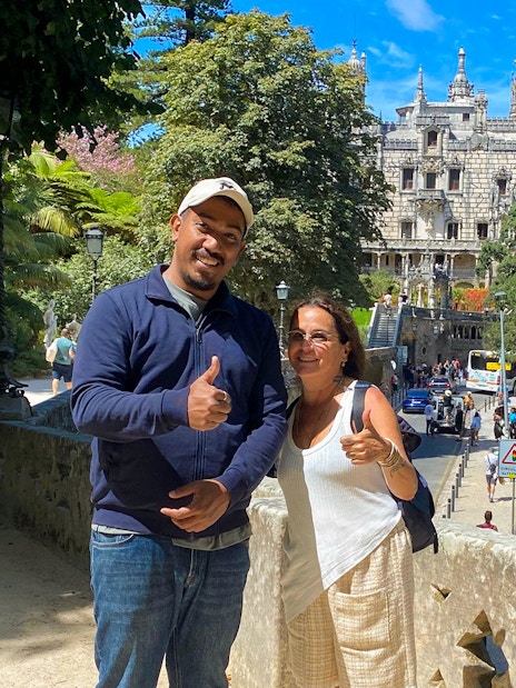 Tourist with guide in front of Quinta da Regaleira, Sintra, Portugal.