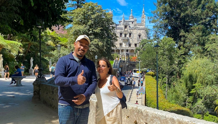 Tourist with guide in front of Quinta da Regaleira, Sintra, Portugal.