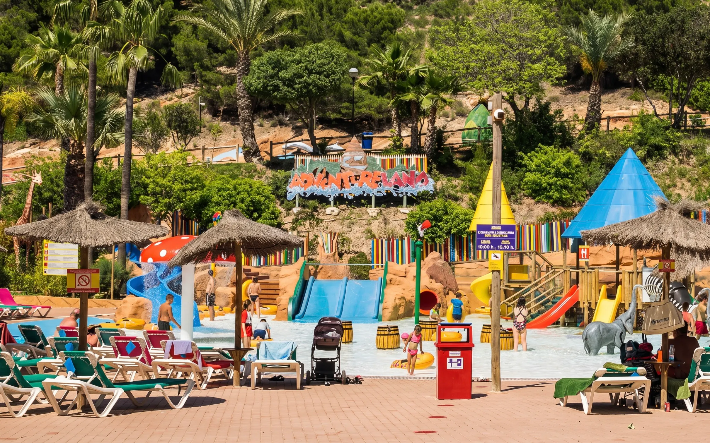 Adventureland water play area at Aqualandia Benidorm, Spain with slides and palm trees.