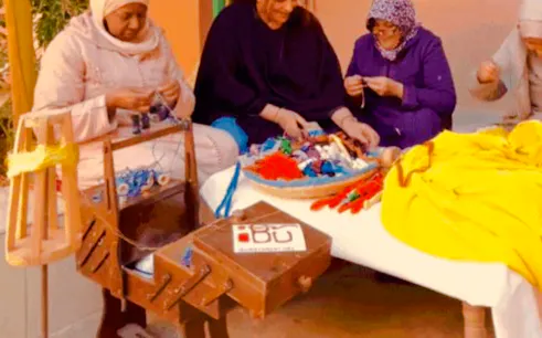 People participating in a textile recycling and sewing workshop in Sidi Youssef, Marrakesh.