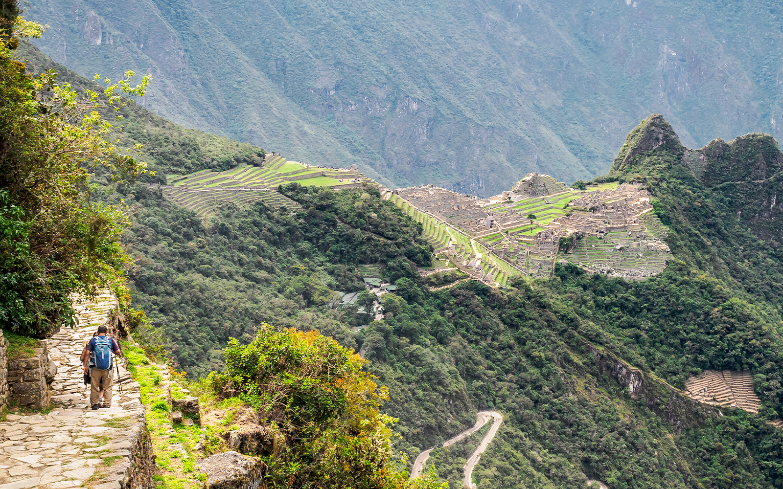 Machu Picchu view from Sun Gate on Inca Trail, Peru, showcasing ancient ruins and mountain landscape.