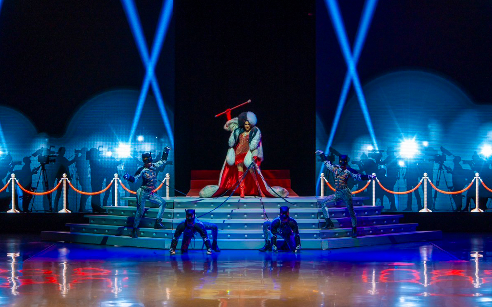 Performers on stage at The Colosseum Show with dramatic lighting and costumes.