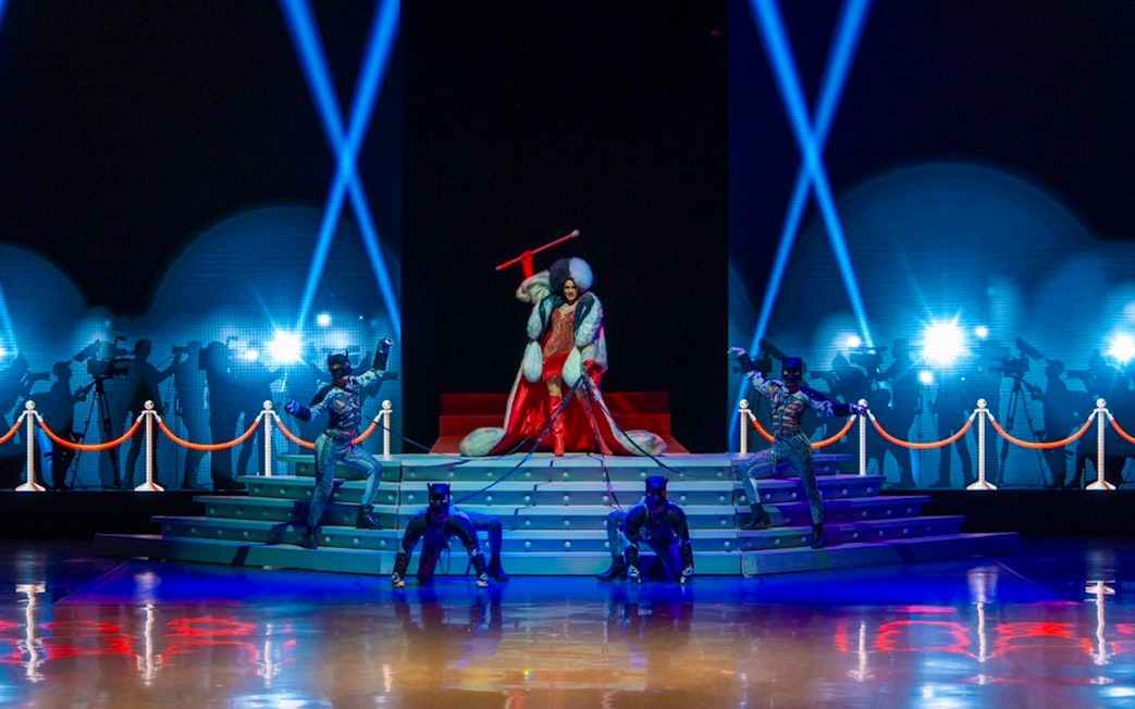 Performers on stage at The Colosseum Show with dramatic lighting and costumes.