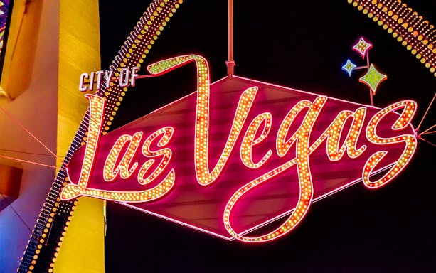Las Vegas neon sign at night, featured on Big Bus Tours.