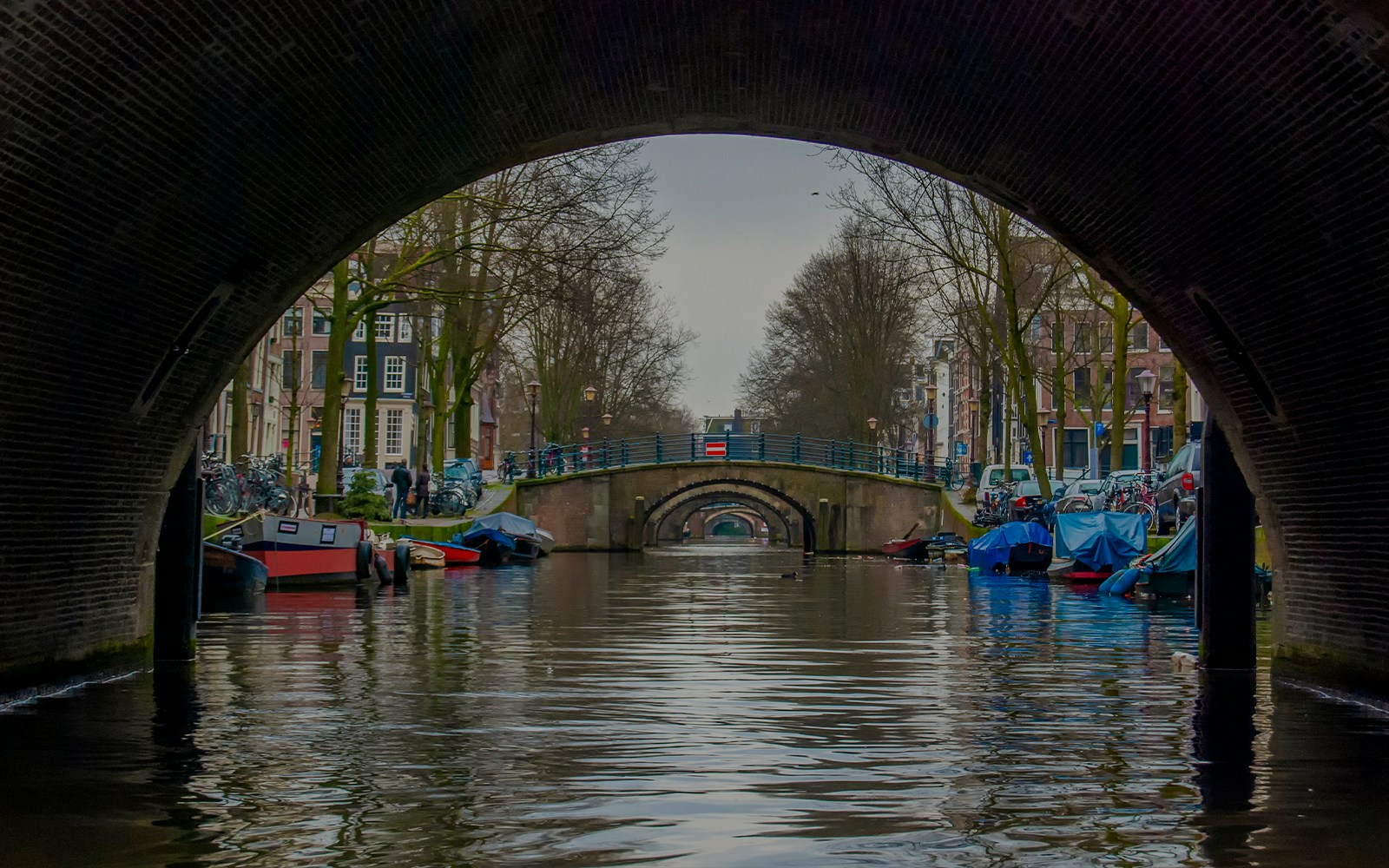 Canal view through archway at Seven Bridges View Point, Amsterdam.