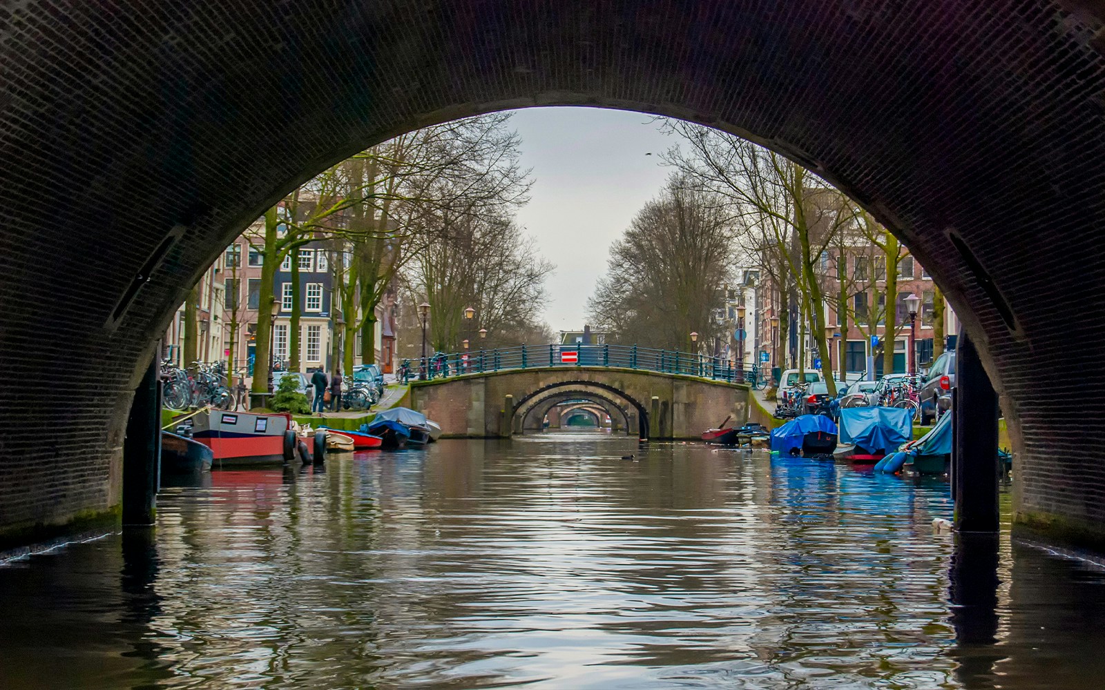 Canal view through archway at Seven Bridges View Point, Amsterdam.