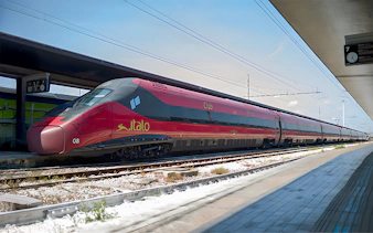 Italo train stationed at a platform in Italy.