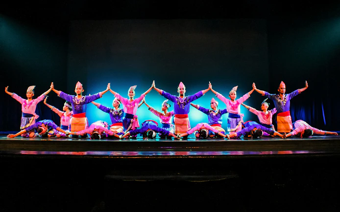 Performers on stage at the Devdan Show in Bali, showcasing traditional Indonesian dance.