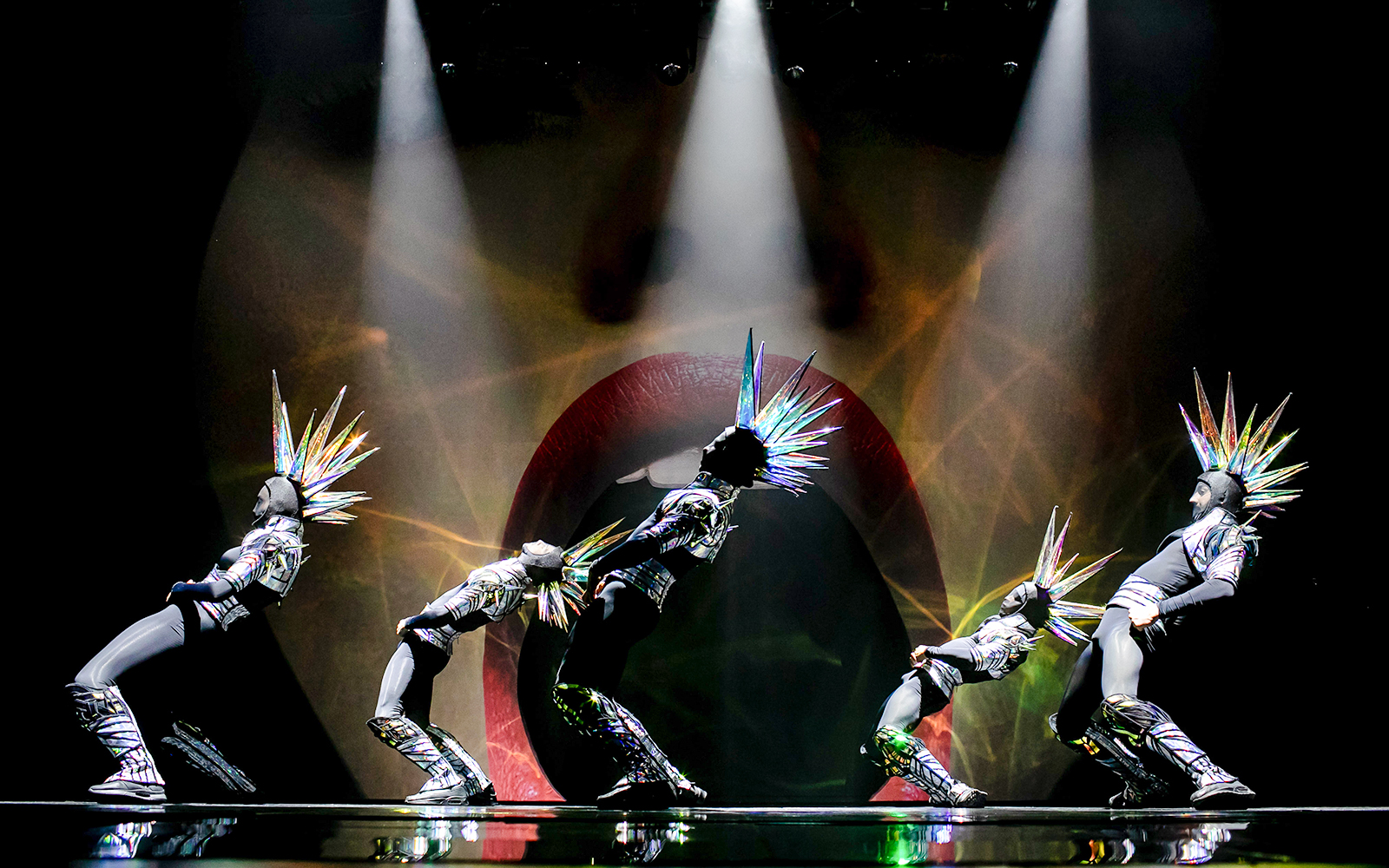 Performers in futuristic costumes with spiked headpieces at Paradis Latin show.