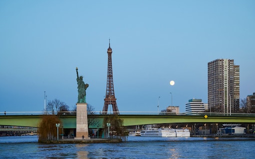 Eiffel Tower and Statue of Liberty from Seine River cruise in Paris.