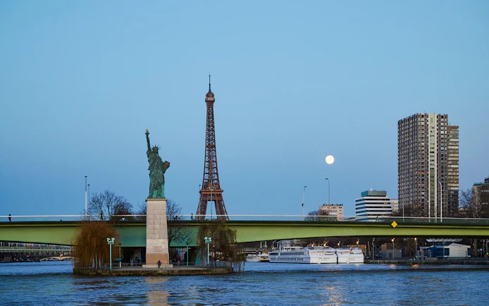 Eiffel Tower and Statue of Liberty from Seine River cruise in Paris.