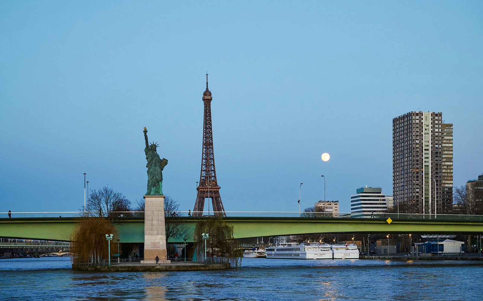 Eiffel Tower and Statue of Liberty from Seine River cruise in Paris.