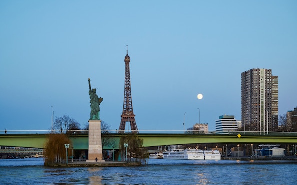Eiffel Tower and Statue of Liberty from Seine River cruise in Paris.
