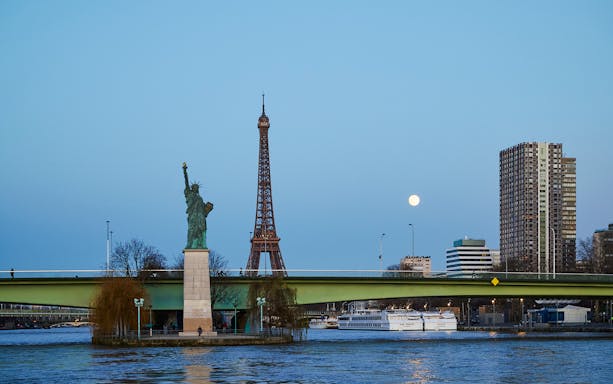 Eiffel Tower and Statue of Liberty from Seine River cruise in Paris.