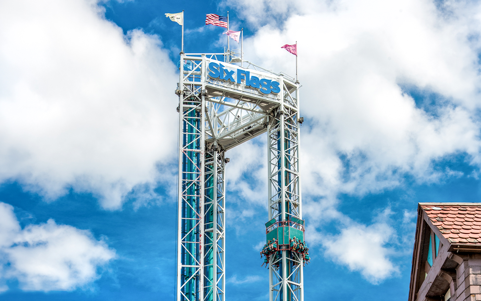 Six Flags New England Scream ride tower against blue sky.