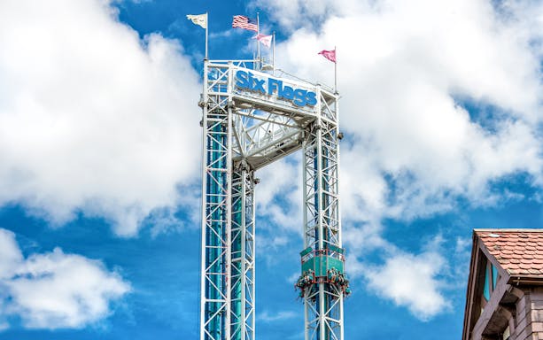 Six Flags New England Scream ride tower against blue sky.