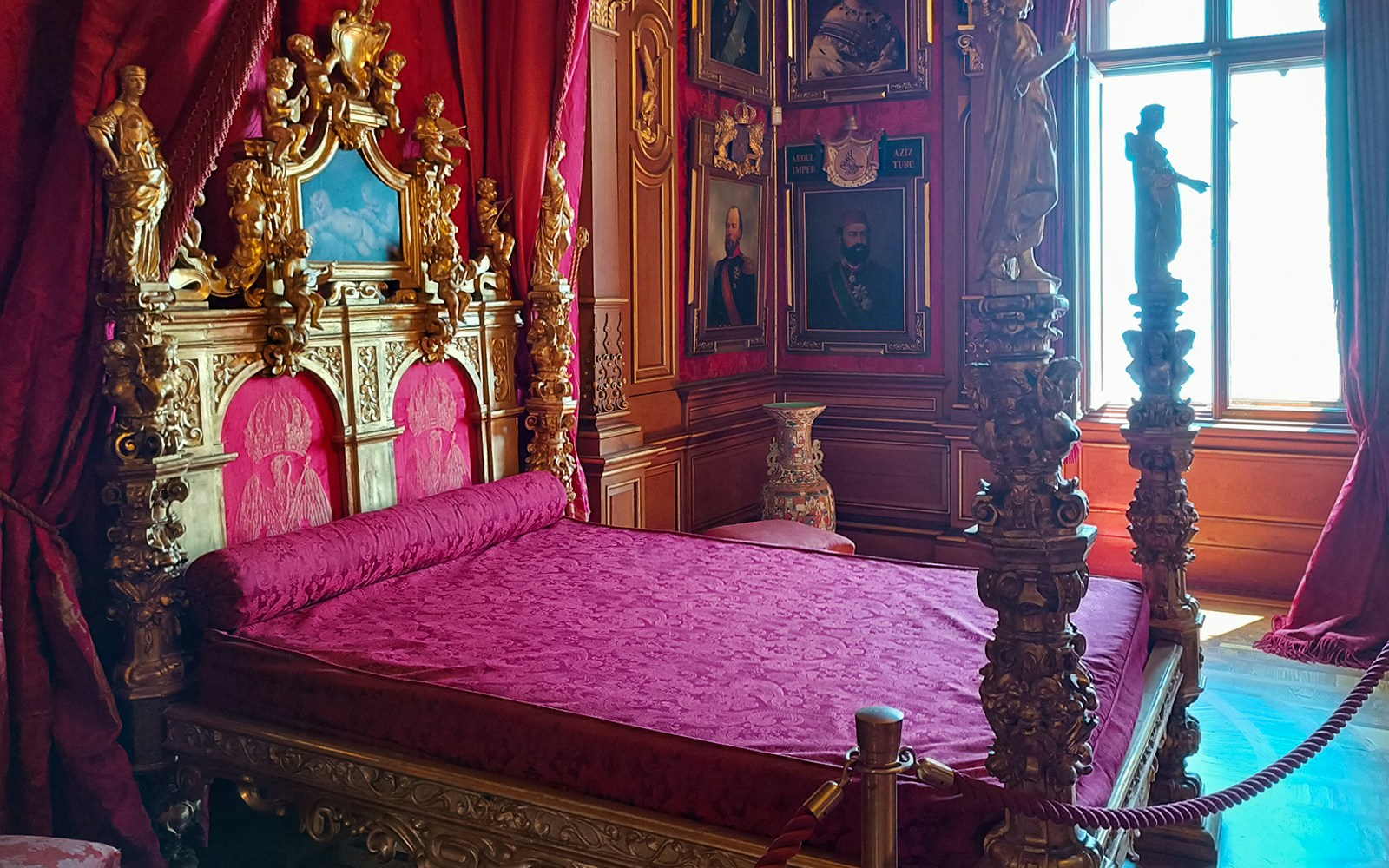 Miramare Castle bedroom with ornate bed and historical furnishings in Trieste, Italy.