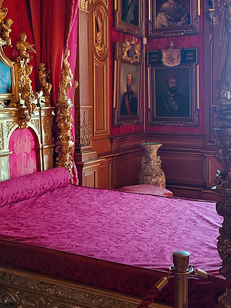 Miramare Castle bedroom with ornate bed and historical furnishings in Trieste, Italy.