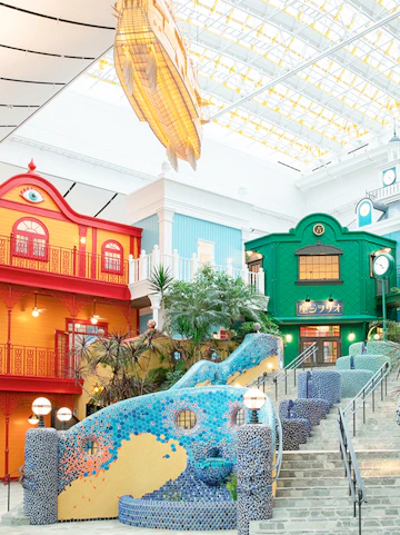 Colorful buildings and mosaic staircase at Ghibli Park, Japan.