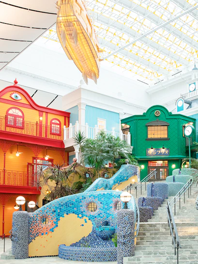 Colorful buildings and mosaic staircase at Ghibli Park, Japan.