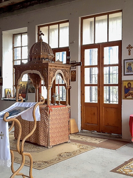 Interior of Berat Castle chapel with religious icons and wooden altar.