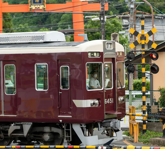 Train passing by a torii gate in Kyoto, Japan, on the Hankyu line.