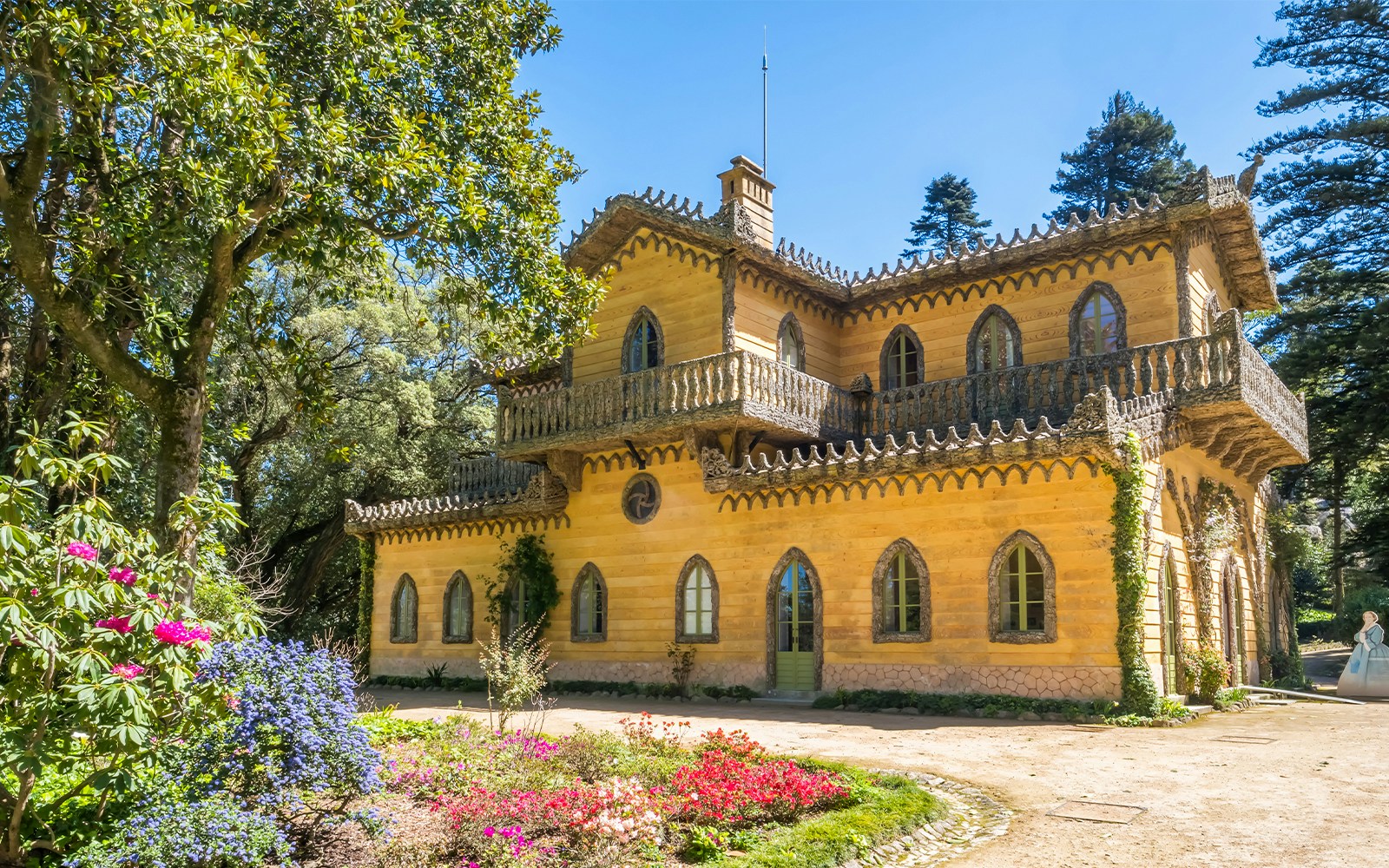 Chalet da Condessa of Edla in Pena Park, Sintra, Portugal surrounded by lush greenery.