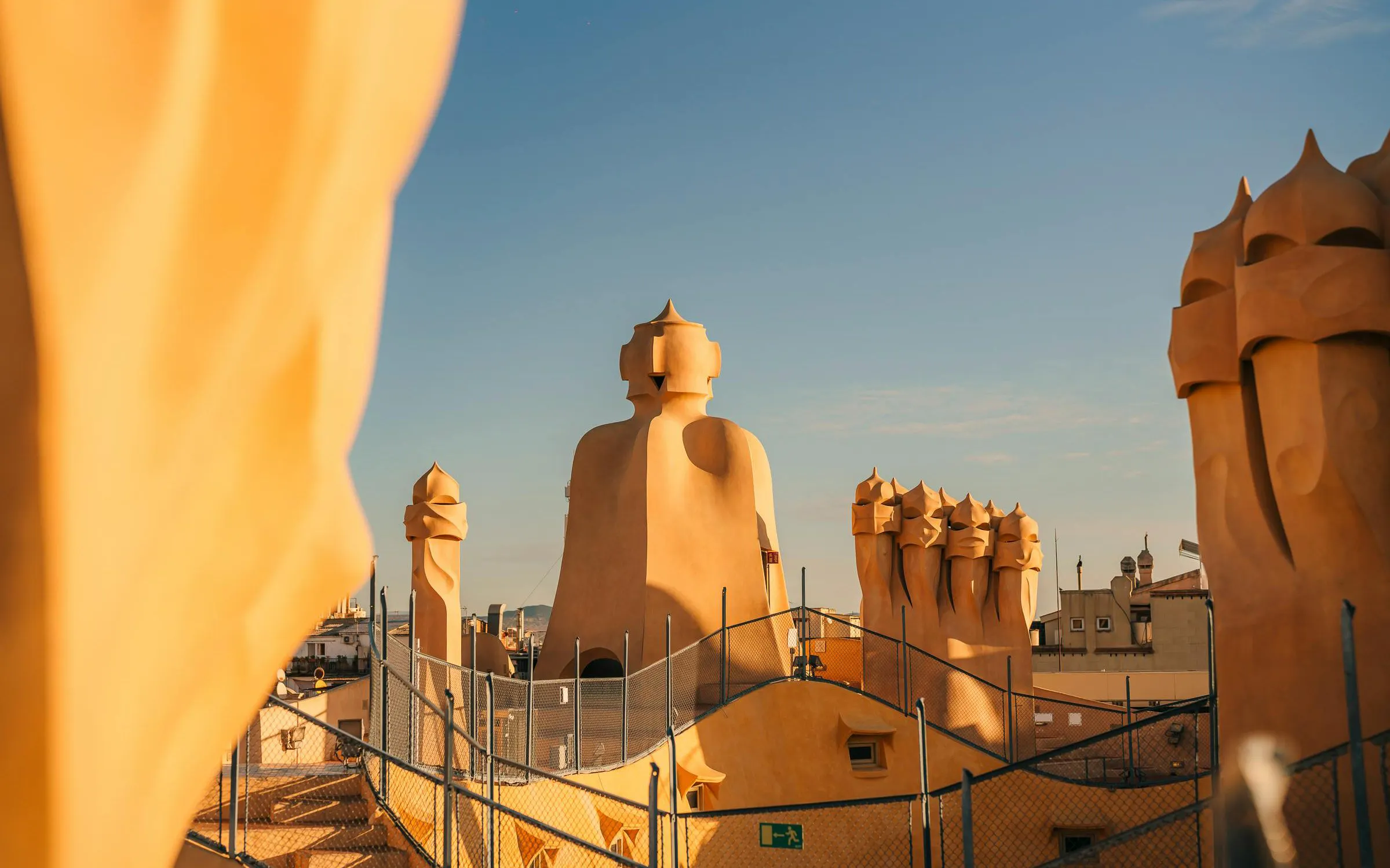 Rooftop chimneys of La Pedrera - Casa Milà during sunset in Barcelona.