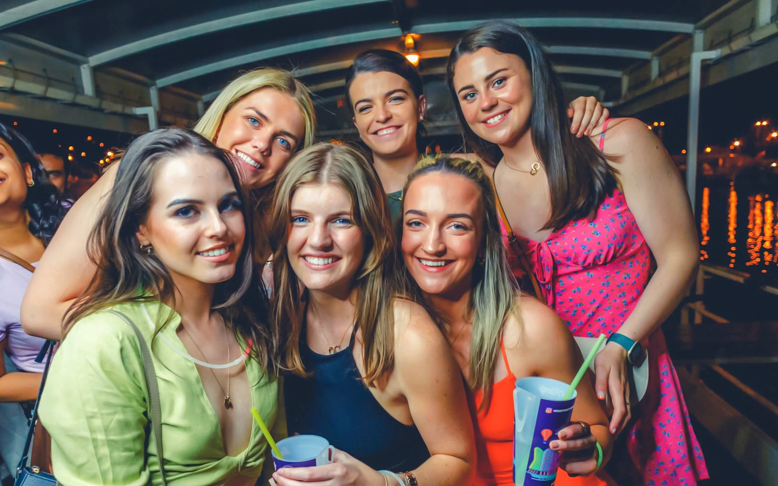 Group enjoying a sunset boat party on the Vltava River in Prague.