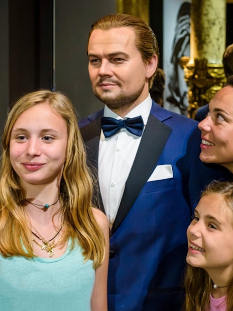Visitors taking a selfie with a wax figure at Grévin Paris Wax Museum.