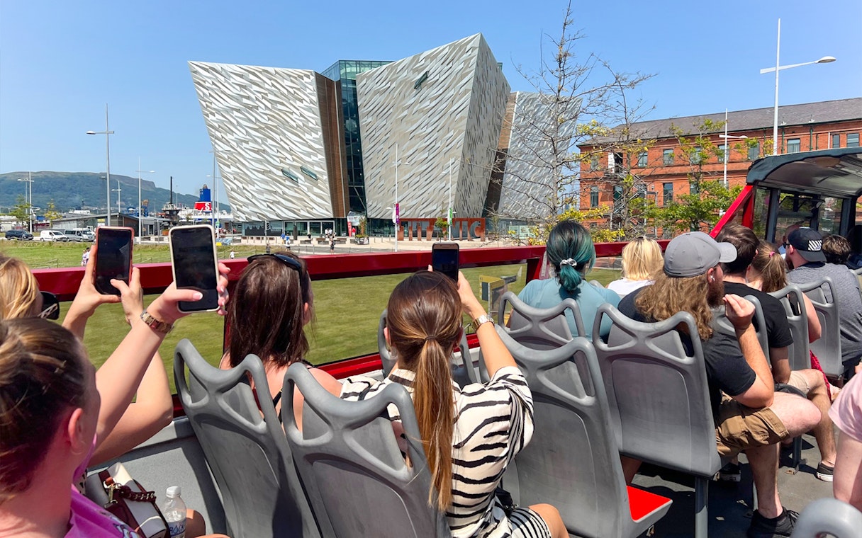 Visitors on a hop-on hop-off bus tour view the Titanic Museum in Belfast.
