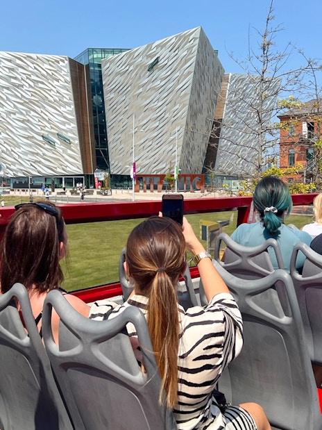 Visitors on a hop-on hop-off bus tour view the Titanic Museum in Belfast.