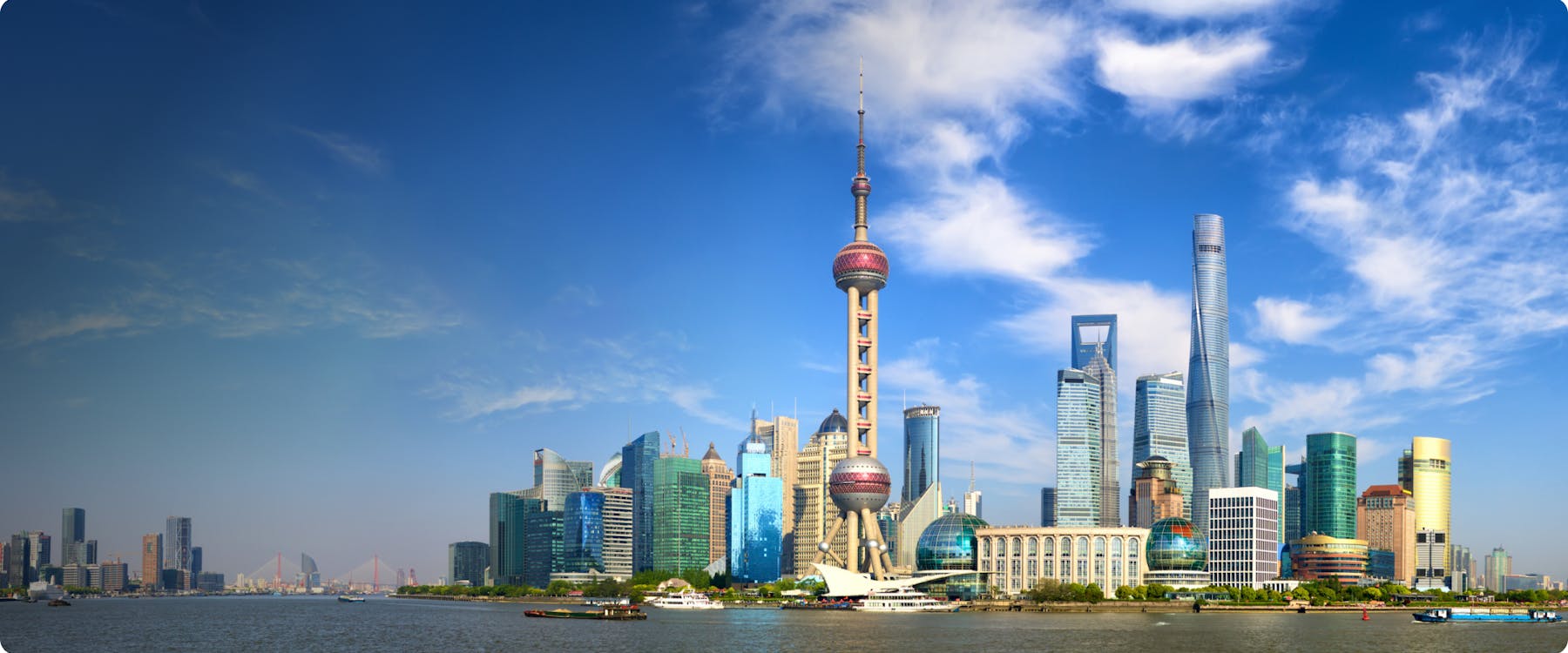 Shanghai skyline with Oriental Pearl Tower and skyscrapers along the Huangpu River.