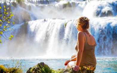 Visitor enjoying the view of waterfalls at Krka National Park, Croatia.