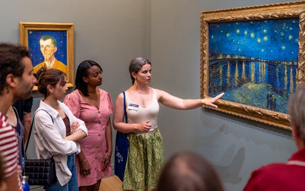 Group tour at Musée d’Orsay viewing Impressionist paintings with guide.
