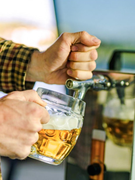 Pouring beer from a tap on a Prague beer boat tour.