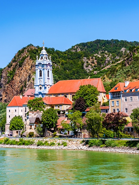 Durnstein village with blue church tower and Danube River in Wachau Valley, Austria.