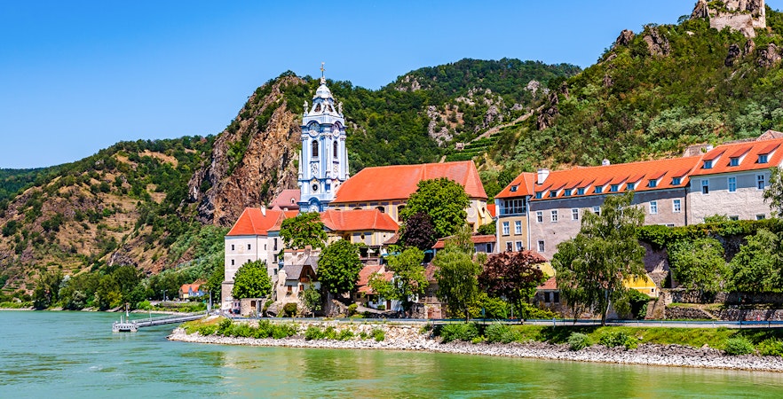 Durnstein village with blue church tower and Danube River in Wachau Valley, Austria.