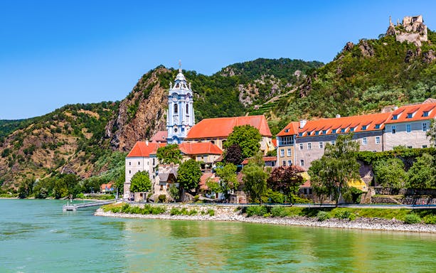 Durnstein village with blue church tower and Danube River in Wachau Valley, Austria.